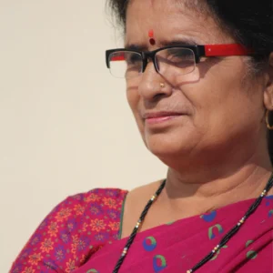 Elderly Indian woman wearing a magenta saree